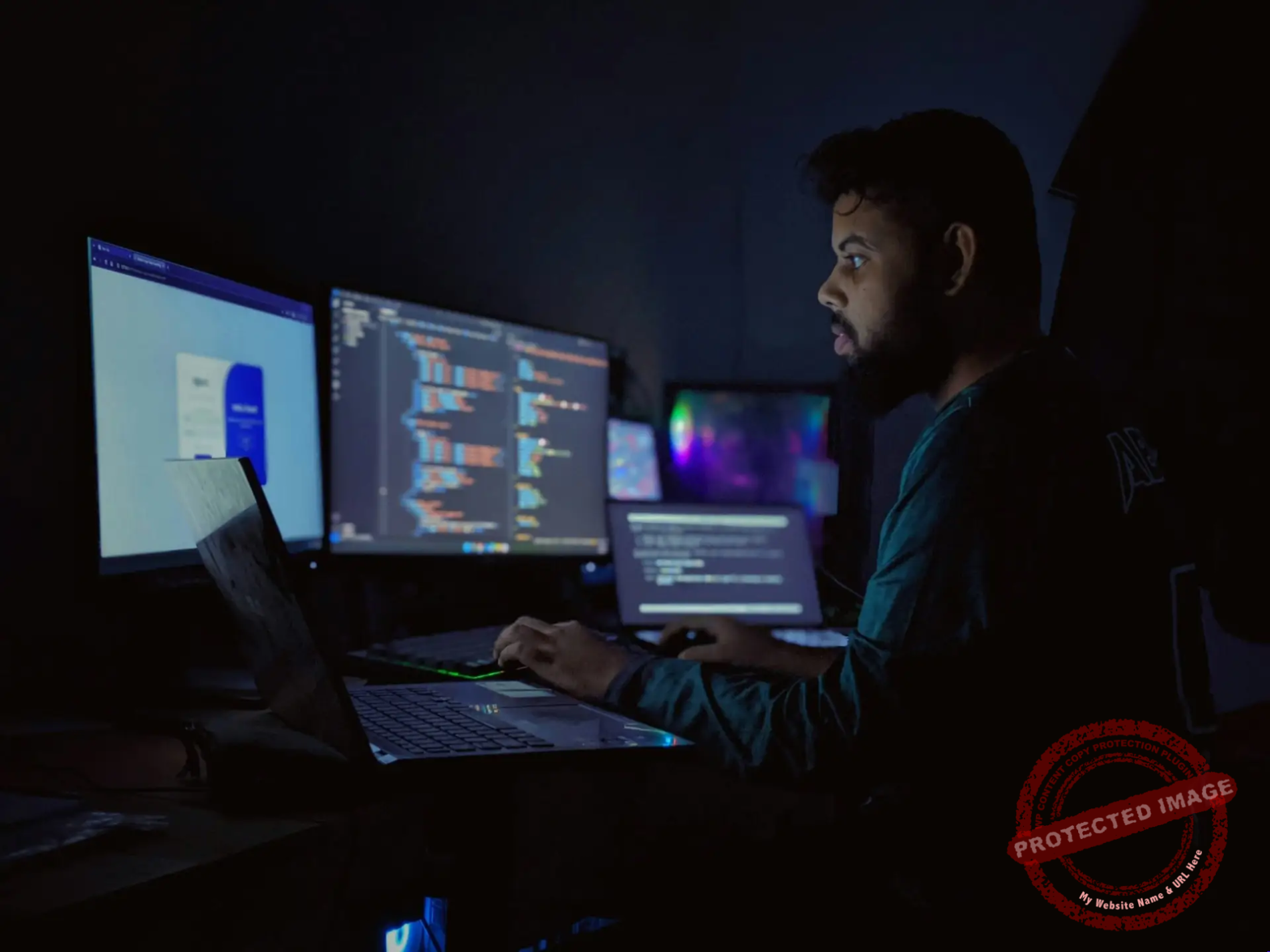 Software developer debugging an AI agent loop late at night across multiple monitors