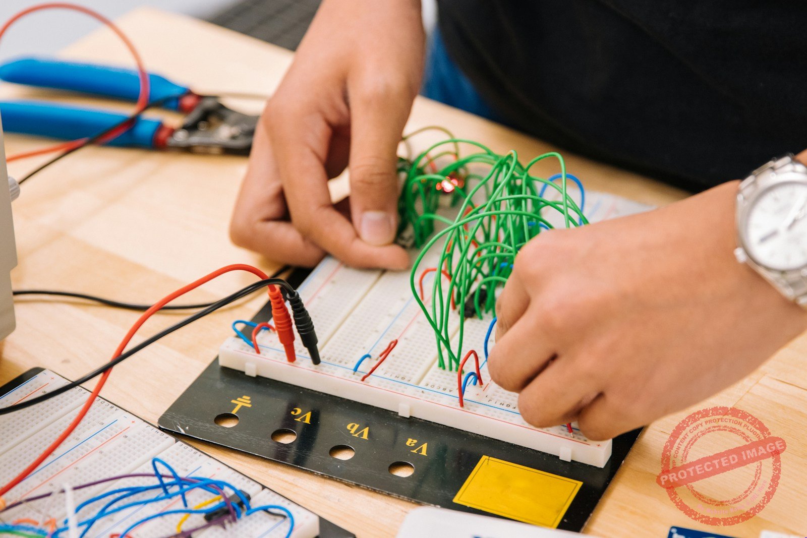 Hands holding an advanced circuit board packed with memory and processor chips