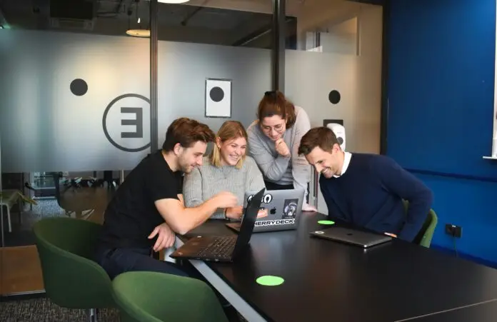Enterprise engineering team reviewing small language model performance dashboards in a modern office