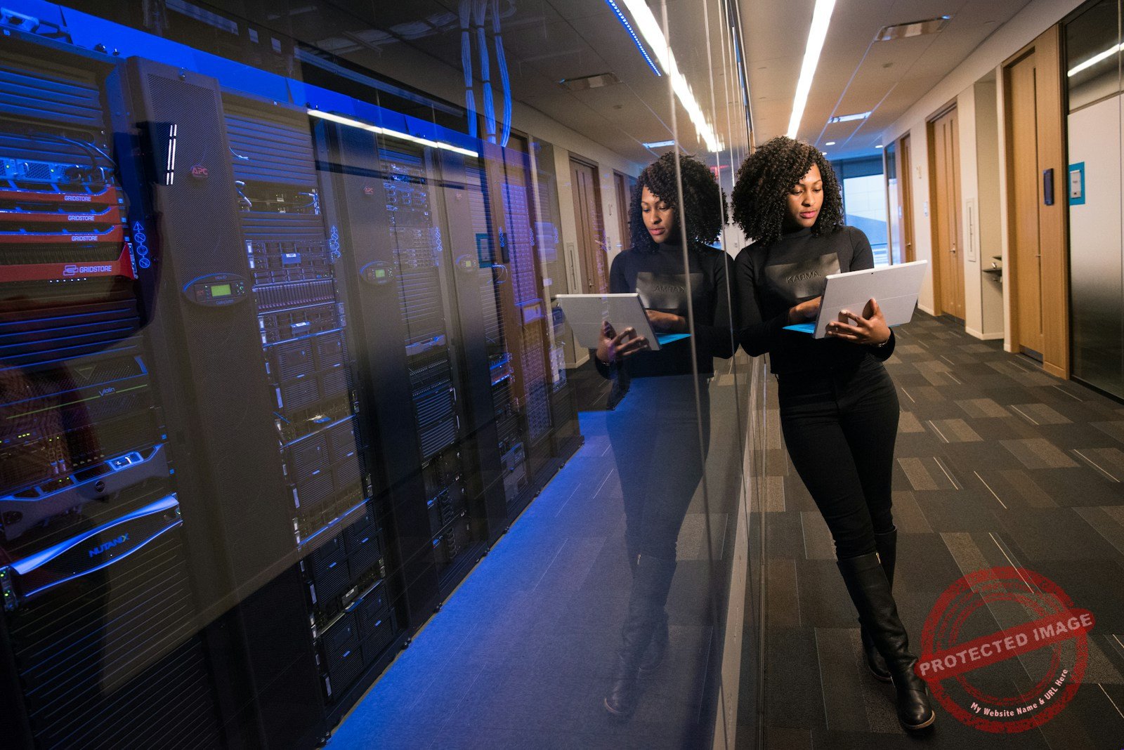 A technology professional works on a laptop amid AI infrastructure