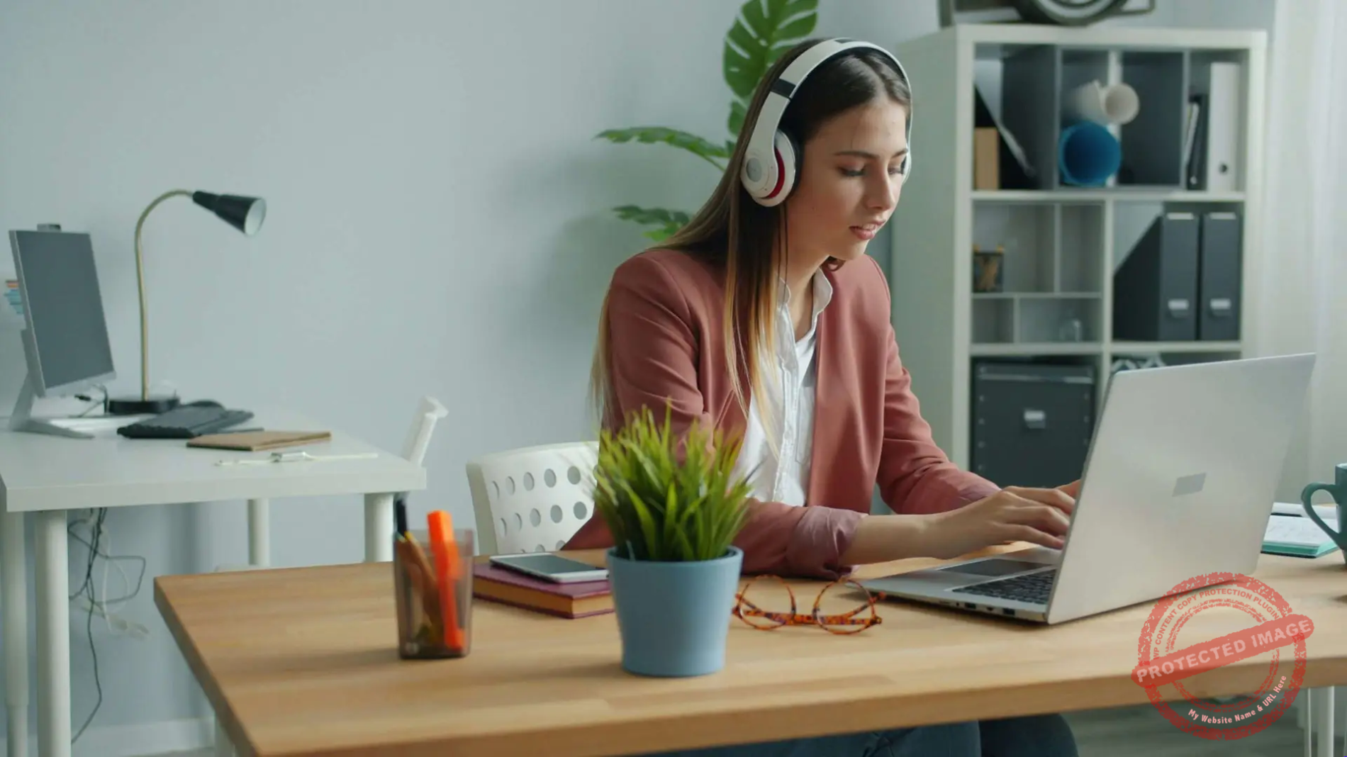 A woman engineer working at a computer where an AI model is being retrained to forget data